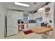 The eat-in kitchen features white cabinetry and essential appliances for meal preparation at 4985 Deerwood Dr, Lakeland, FL 33810