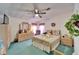 Bright main bedroom with a ceiling fan, floral decorations, and a comfortable bed at 4985 Deerwood Dr, Lakeland, FL 33810