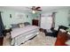 Cozy bedroom with a ceiling fan, private access to the backyard, and carpet at 5051 Ironwood Trl, Bartow, FL 33830