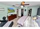 Bedroom featuring a ceiling fan and a TV mounted on the wall at 5051 Ironwood Trl, Bartow, FL 33830