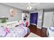 Bedroom featuring wood floors, ceiling fan, and built-in shelving at 5051 Ironwood Trl, Bartow, FL 33830