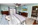 Bedroom with a ceiling fan, TV, and a private door that leads to the backyard at 5051 Ironwood Trl, Bartow, FL 33830