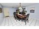 Well-lit dining room featuring a dark wood table with seating for six at 5051 Ironwood Trl, Bartow, FL 33830