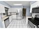 Well-lit kitchen featuring stainless steel appliances and a skylight for natural light at 5051 Ironwood Trl, Bartow, FL 33830