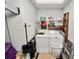 Bright laundry room with washer and dryer, shelving, and block-wall construction at 5051 Ironwood Trl, Bartow, FL 33830