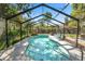 Stunning private pool with a screened enclosure, lush landscaping, and ample space for relaxation at 5051 Ironwood Trl, Bartow, FL 33830