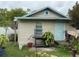 Back exterior of house showing door to porch with grill and foliage at 5636 Old Highway 37, Lakeland, FL 33811