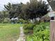 Brick path through a lush backyard garden with various plants and greenery at 5636 Old Highway 37, Lakeland, FL 33811