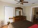 Bedroom featuring a ceiling fan and dresser with a mirror, offering a cozy and functional space at 5636 Old Highway 37, Lakeland, FL 33811