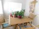 Bright dining area with a wooden table set for four, creating a cozy space for meals and gatherings at 5636 Old Highway 37, Lakeland, FL 33811