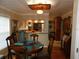 Inviting dining area with wood table and view into the kitchen featuring modern appliances and abundant natural light at 5636 Old Highway 37, Lakeland, FL 33811