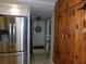 Mudroom off of kitchen with stainless refrigerator, wood storage, and view into the entryway at 5636 Old Highway 37, Lakeland, FL 33811