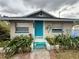 Charming home featuring a bright blue front door and vibrant landscaping at 5636 Old Highway 37, Lakeland, FL 33811