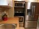 Close-up of kitchen stainless steel appliances, sink, and tile backsplash at 5636 Old Highway 37, Lakeland, FL 33811