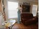 Cozy living room with a brown leather sofa, decorative lamp, and artwork, creating a comfortable and inviting space at 5636 Old Highway 37, Lakeland, FL 33811