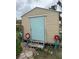 Backyard storage shed with cinder block steps and potted plants at 5636 Old Highway 37, Lakeland, FL 33811