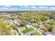 An aerial view of a residential neighborhood with tree-lined streets, pools, and well-kept lawns at 615 Carey Pl, Lakeland, FL 33803