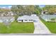 Aerial view of cozy single-story home with green lawn and mature trees at 615 Carey Pl, Lakeland, FL 33803