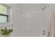 Bathroom with white tiled walls and a window at 615 Carey Pl, Lakeland, FL 33803