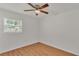 Cozy bedroom featuring a ceiling fan, wood flooring, natural light, and serene ambiance for a peaceful space at 615 Carey Pl, Lakeland, FL 33803