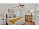 Bright bedroom featuring a ceiling fan, ensuite access, closet, and wood flooring for a comfortable and stylish space at 615 Carey Pl, Lakeland, FL 33803