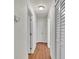 Hallway with wood floors and neutral paint with closet doors and doors to bedrooms and bathrooms at 615 Carey Pl, Lakeland, FL 33803