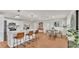 Bright kitchen and dining area with stainless appliances, a quartz breakfast bar, and stylish furnishings at 615 Carey Pl, Lakeland, FL 33803