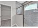 Bathroom with a tiled shower and access to closet at 6185 Gracie Pl, Lakeland, FL 33812