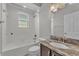 Bathroom with a tub and vanity with granite counters at 6185 Gracie Pl, Lakeland, FL 33812