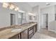 Bathroom with a double vanity, granite countertops, a large mirror, and modern lighting at 6185 Gracie Pl, Lakeland, FL 33812