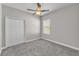 Bedroom featuring a closet, window and a ceiling fan at 6185 Gracie Pl, Lakeland, FL 33812