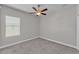 Cozy bedroom featuring a ceiling fan and a window with natural light at 6185 Gracie Pl, Lakeland, FL 33812