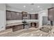 Modern kitchen featuring stainless steel appliances, granite countertops, and dark wood cabinets at 6185 Gracie Pl, Lakeland, FL 33812