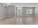 Bright living room showcasing tile floors, fresh paint, and a decorative chandelier at 6185 Gracie Pl, Lakeland, FL 33812