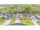 Aerial view of a home with a well-manicured lawn, a 3-car garage, and a neutral color scheme at 6923 Highlands Creek Ave, Lakeland, FL 33813