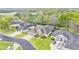 Aerial view of a home with a well-manicured lawn, a 2-car garage, and a neutral color scheme at 6923 Highlands Creek Ave, Lakeland, FL 33813