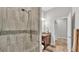 Shower with decorative tile and modern fixtures in updated bathroom at 6923 Highlands Creek Ave, Lakeland, FL 33813