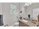 Powder bath featuring granite counters, decor, and bright natural light from a window at 6923 Highlands Creek Ave, Lakeland, FL 33813