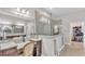 Bathroom featuring dual vanities, a makeup vanity, a glass shower and a walk-in closet at 6923 Highlands Creek Ave, Lakeland, FL 33813