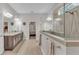 Bathroom with dual vanities, a clear glass shower, and wood-look tile flooring at 6923 Highlands Creek Ave, Lakeland, FL 33813