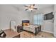 Bedroom with dark furniture, ceiling fan and flat screen TV at 6923 Highlands Creek Ave, Lakeland, FL 33813