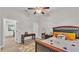 Bedroom with dark furniture, ceiling fan and unique area rug at 6923 Highlands Creek Ave, Lakeland, FL 33813