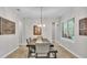 Bright dining room featuring a wood table, pendant lighting, and light wood floors at 6923 Highlands Creek Ave, Lakeland, FL 33813