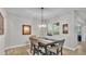 Elegant dining room with contemporary table set and decorative lighting fixture at 6923 Highlands Creek Ave, Lakeland, FL 33813