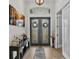 Bright foyer with stylish tile flooring and a decorative console table beneath a modern light fixture at 6923 Highlands Creek Ave, Lakeland, FL 33813