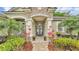 Inviting front entrance with double doors, stone archway, and manicured landscaping at 6923 Highlands Creek Ave, Lakeland, FL 33813