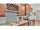 Close-up of kitchen with wine rack, granite countertops, and stainless-steel appliances at 6923 Highlands Creek Ave, Lakeland, FL 33813