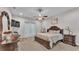 Comfortable main bedroom with a ceiling fan, neutral carpet, and a private entry to the lanai at 6923 Highlands Creek Ave, Lakeland, FL 33813