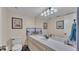 Bright bathroom featuring a large mirror, neutral cabinets, and nautical-themed decor at 707 Carpenters Way # 37, Lakeland, FL 33809