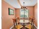 Cozy dining area with a round table, four chairs, and a window with blinds at 707 Carpenters Way # 37, Lakeland, FL 33809